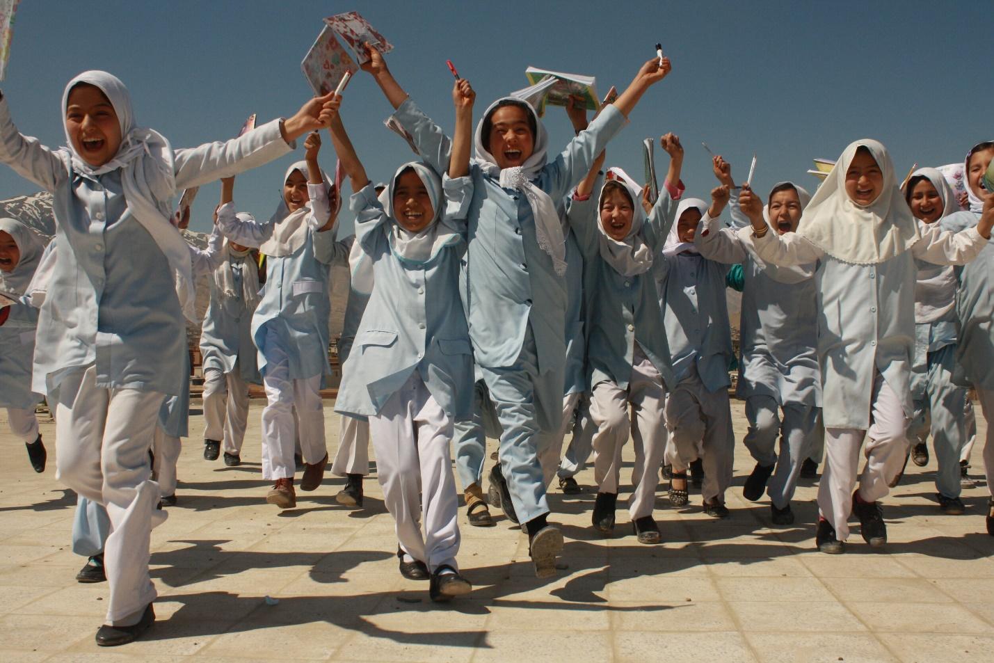 A group of people in white clothes are holding hands.