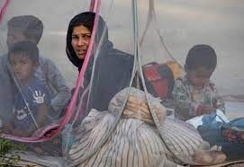 A woman in a veil and some people under a mosquito net