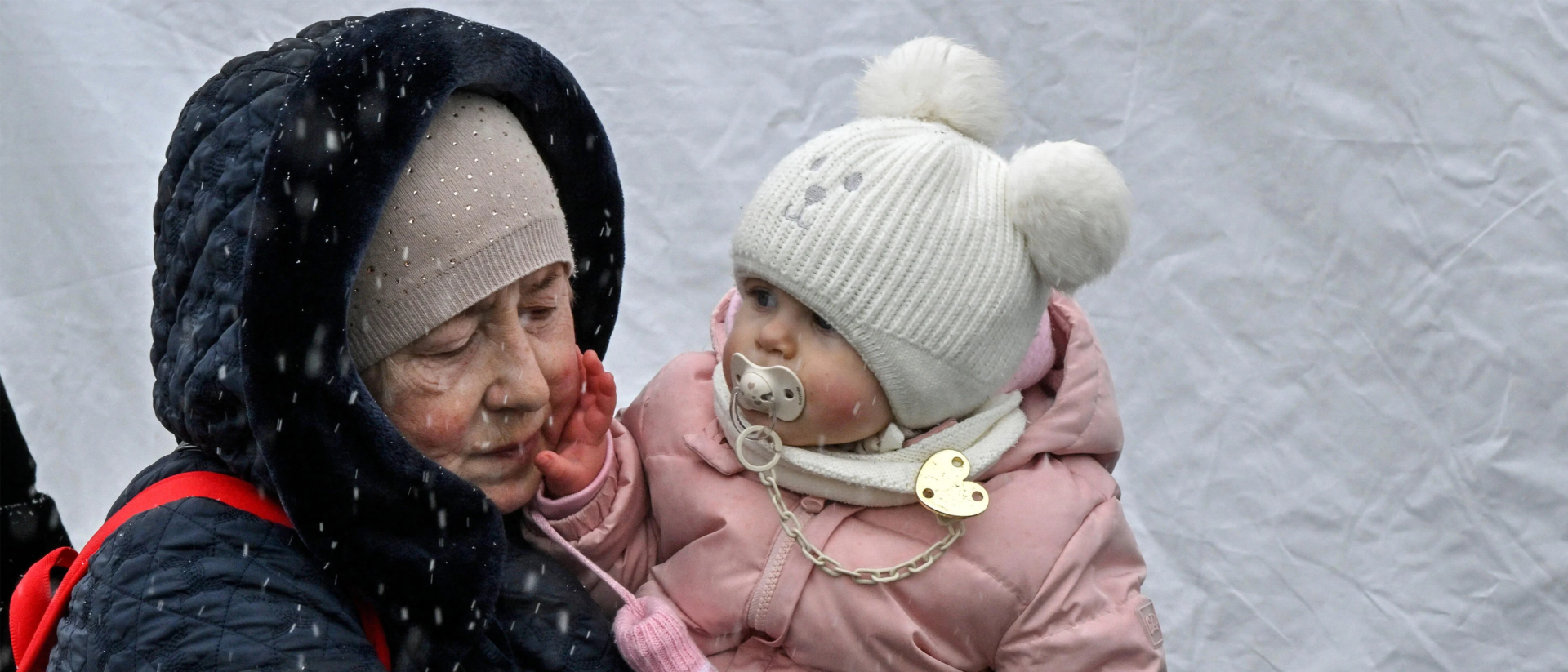 A woman holding a baby in her arms.