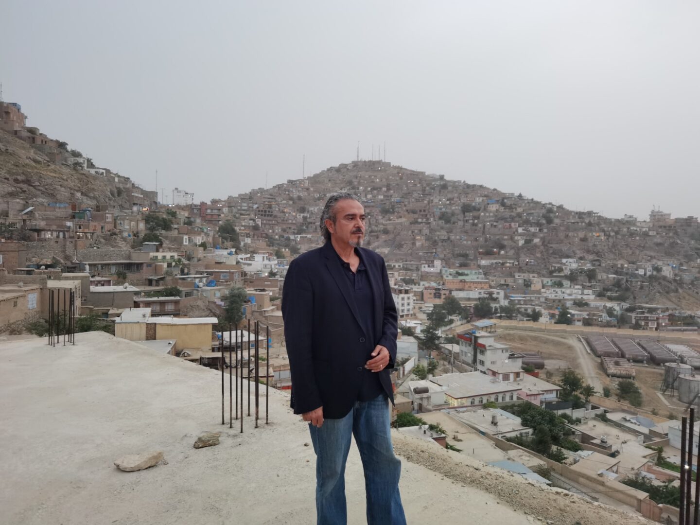 A man standing on top of a hill.